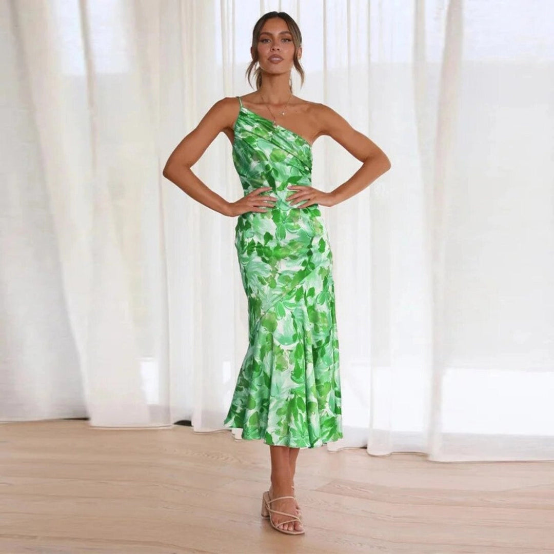 Summer women's floral sleeveless maxi dress with an asymmetrical hem, a stylish party outfit.