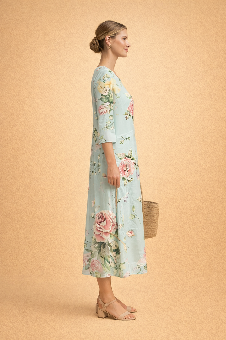 Close-up of vibrant floral print on an elegant women's midi dress, showcasing summer fashion & airy fabric.