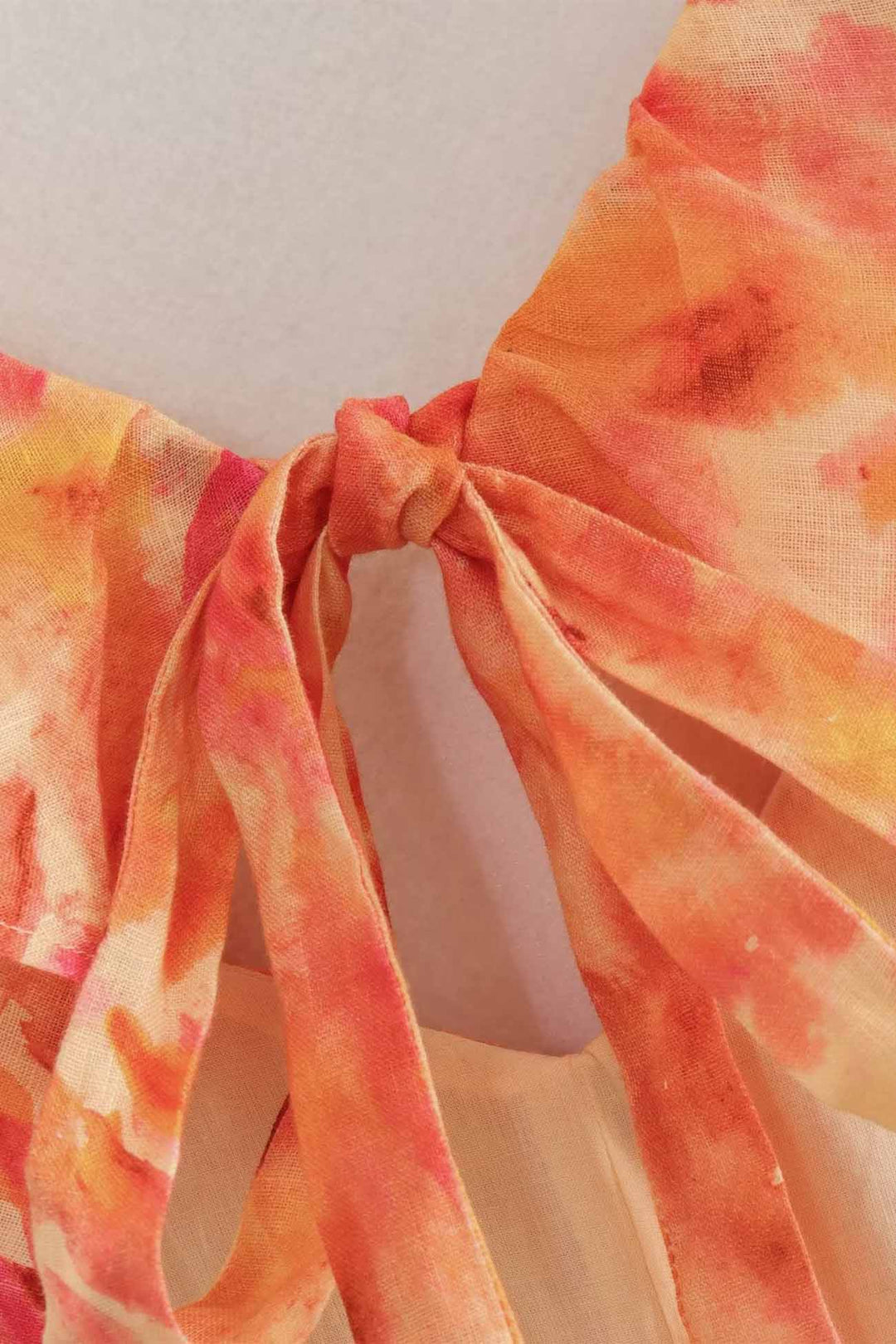 Detailed image of the fabric texture and colorful floral print on a women's ruffle maxi dress.