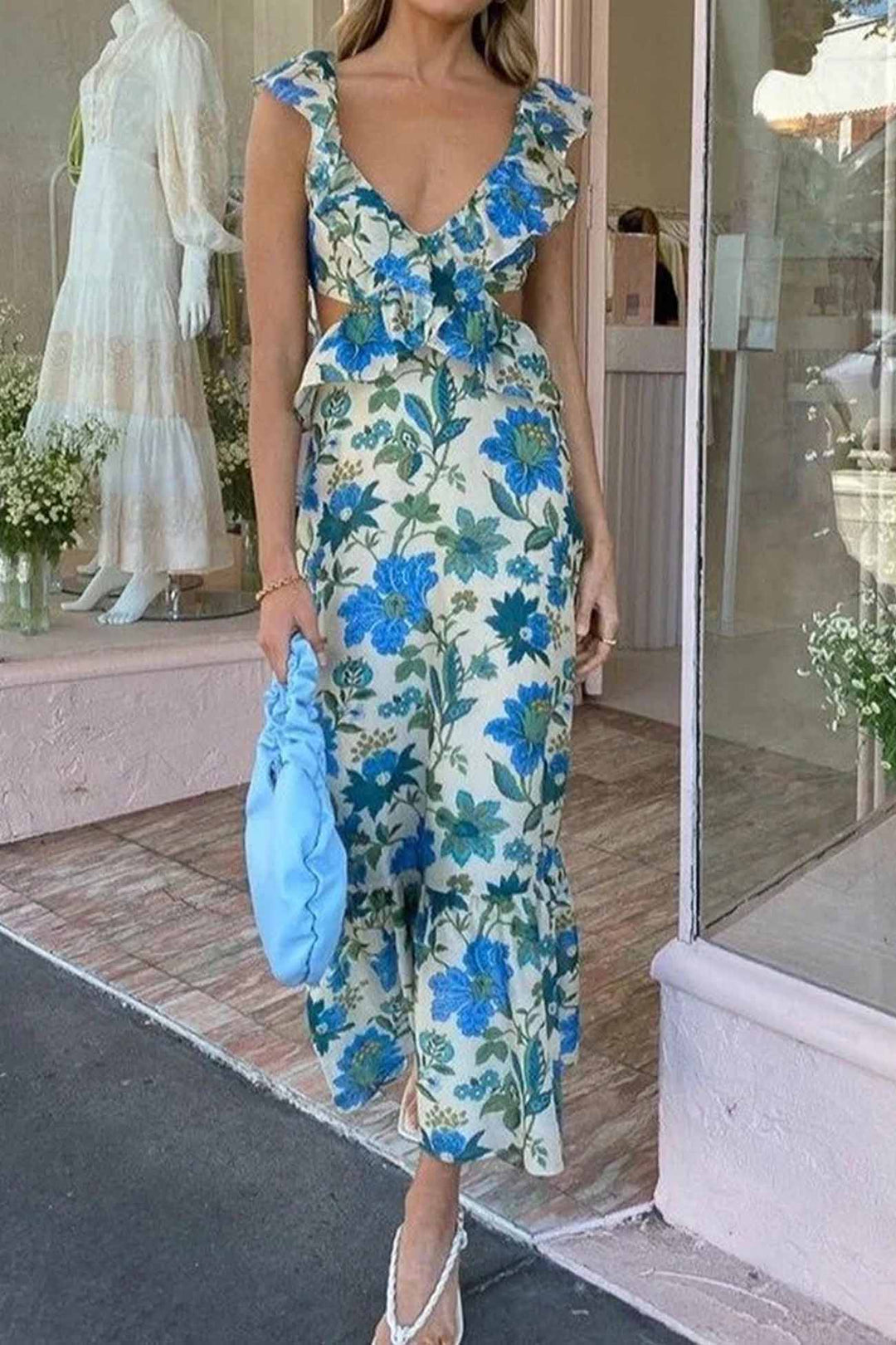 Close-up of the delicate floral pattern and ruffle details on an elegant women's maxi dress.
