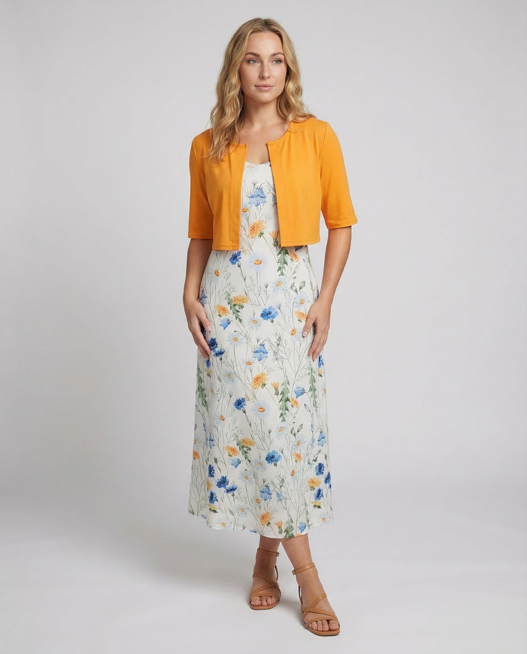 Elegant women's floral two-piece dress set with crop top and midi skirt. Perfect for summer style.