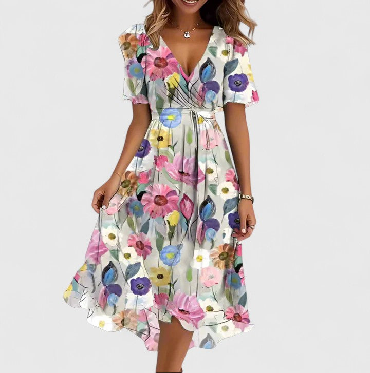 Soft, elegant women's V-neck floral midi dress. Features a beautiful vibrant print and flowy silhouette for summer.