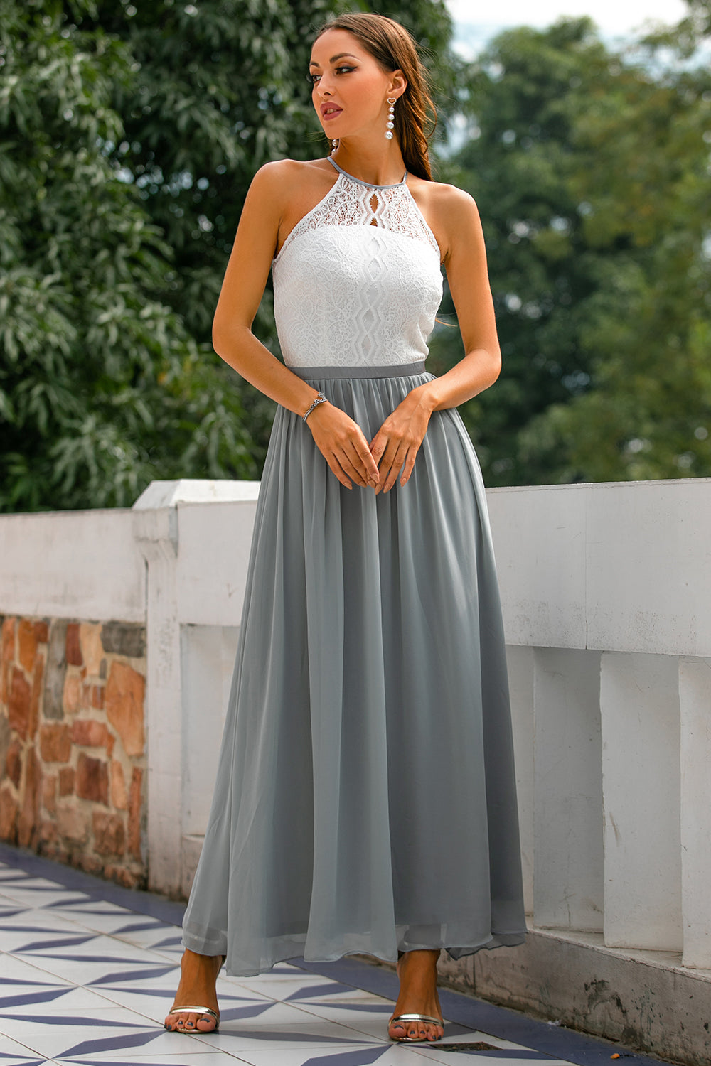 Wedding guest attire: a beautiful women's halter maxi dress in a delicate color.