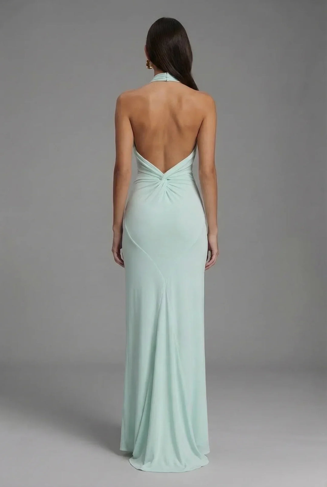 Stunning backless halter neck ruched maxi dress for women. Ideal as an evening gown, cocktail dress, or wedding guest attire.