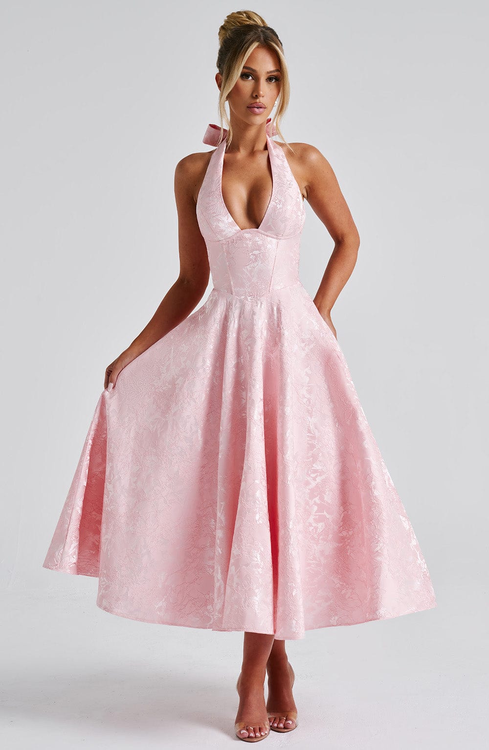 Elegant women's halter neck midi dress in a flowing silhouette, perfect for wedding guests.