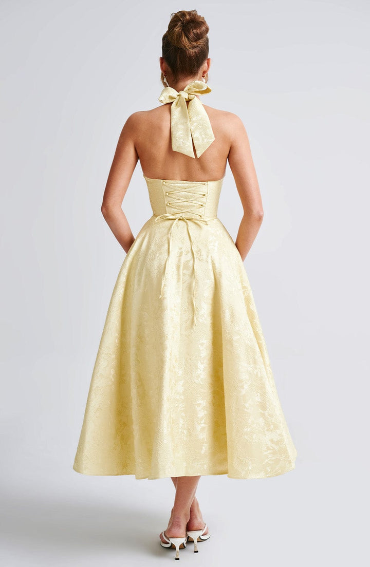 Side profile of the women's elegant halter neck midi dress, emphasizing its silhouette.