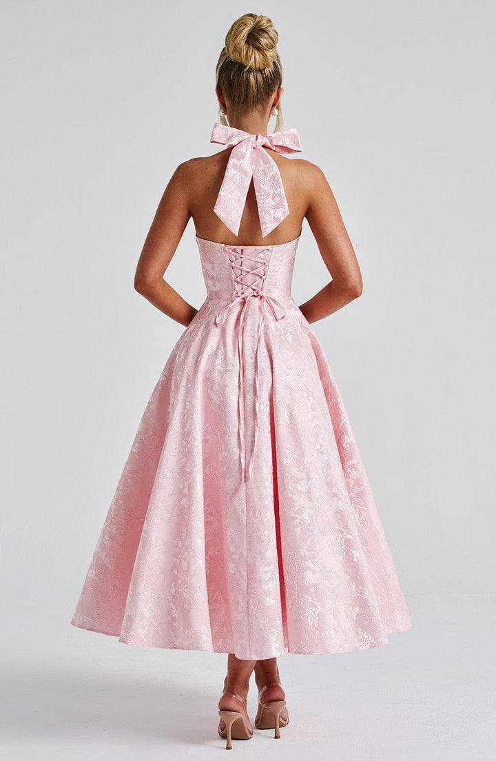 Women's chic halter neck midi dress with a flattering cut, suitable for special occasions.