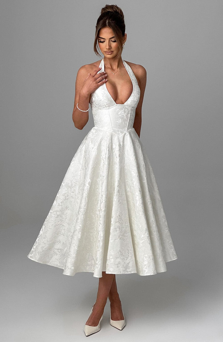 Close-up of the elegant halter neckline and bodice of a women's midi dress.