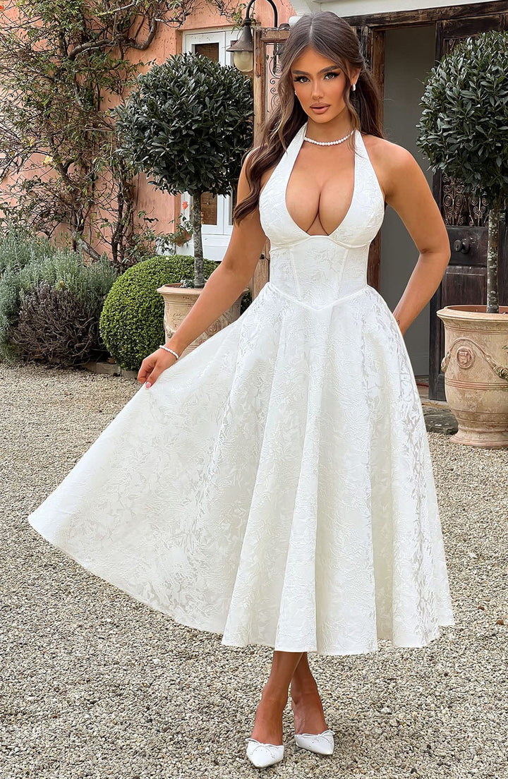 Back view of the elegant halter neck midi dress, showing a sophisticated open back detail.