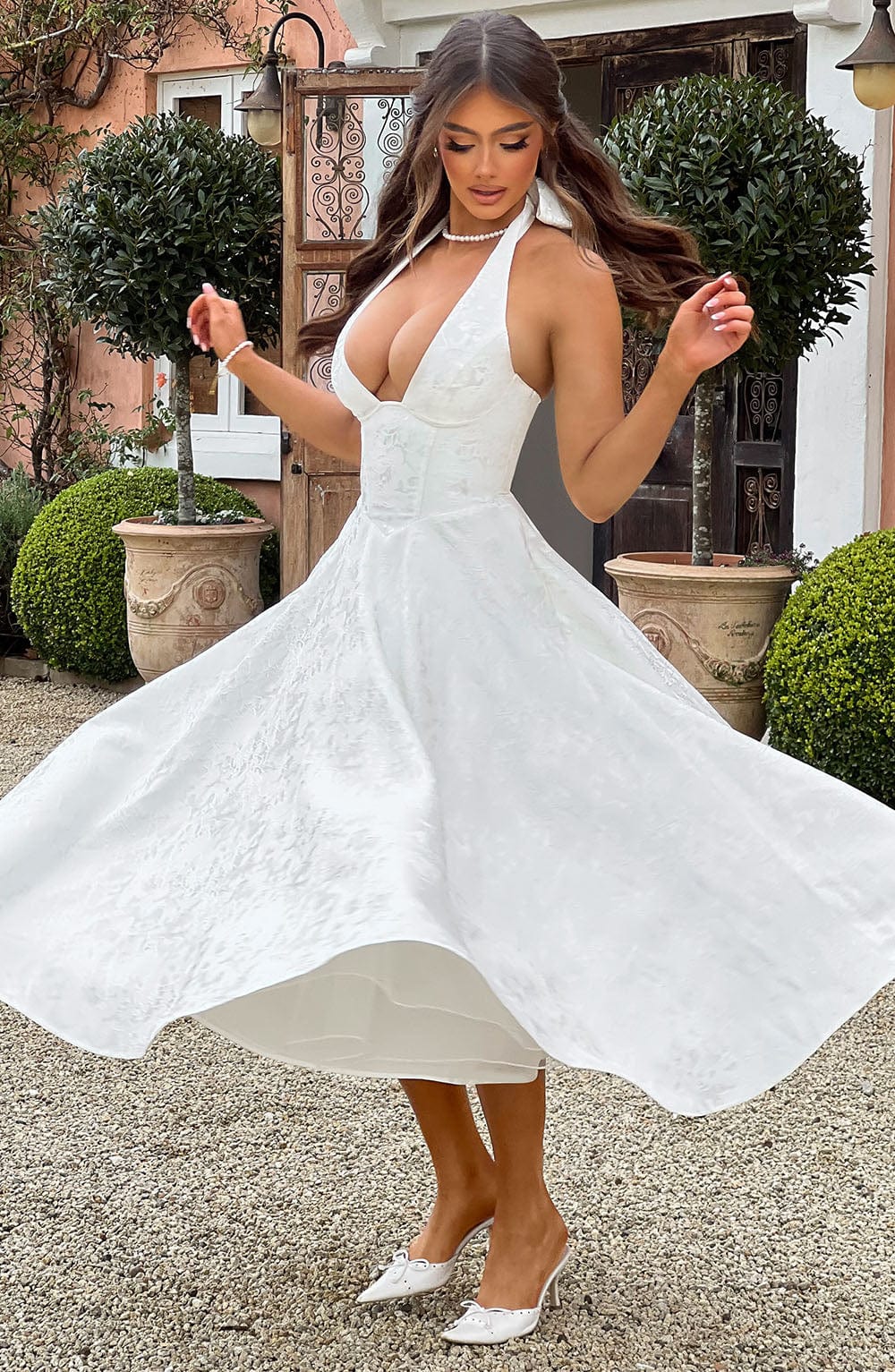 Fashionable women's halter neck midi dress, a versatile piece for various elegant settings.