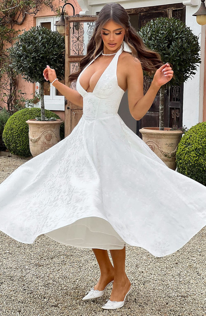 Fashionable women's halter neck midi dress, a versatile piece for various elegant settings.