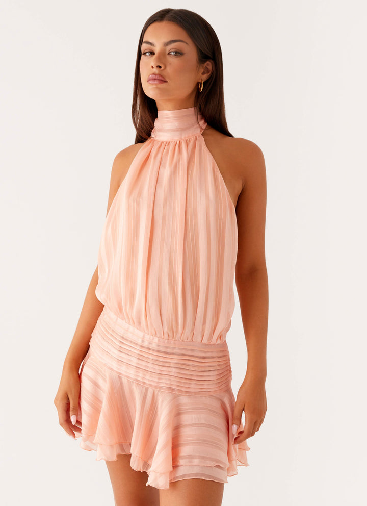 The soft fabric of a halter neck ruffle mini dress, comfortable and stylish