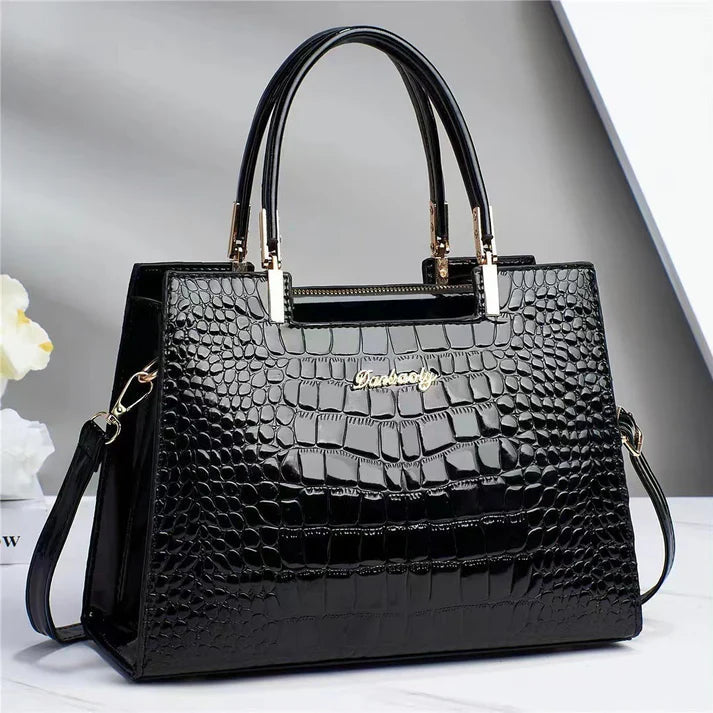 Sleek women's glossy finish handbag. Chic & elegant accessory, elevating any outfit for work or evening.