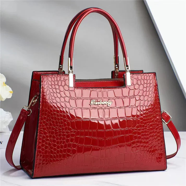 Women's elegant glossy handbag. A stylish purse for work, parties, or everyday fashion needs.