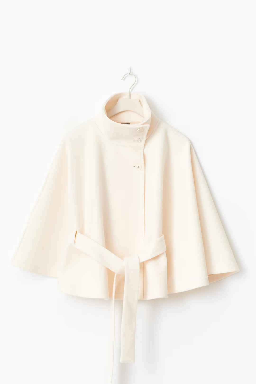 Women's belted winter coat, high collar, in a dark color, highlighting its sleek and classic fashion.