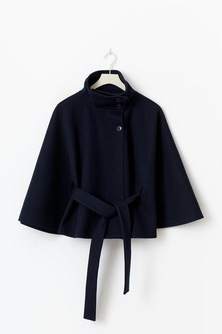 Back view of a women's high collar belted winter coat, showing its elegant silhouette and design.