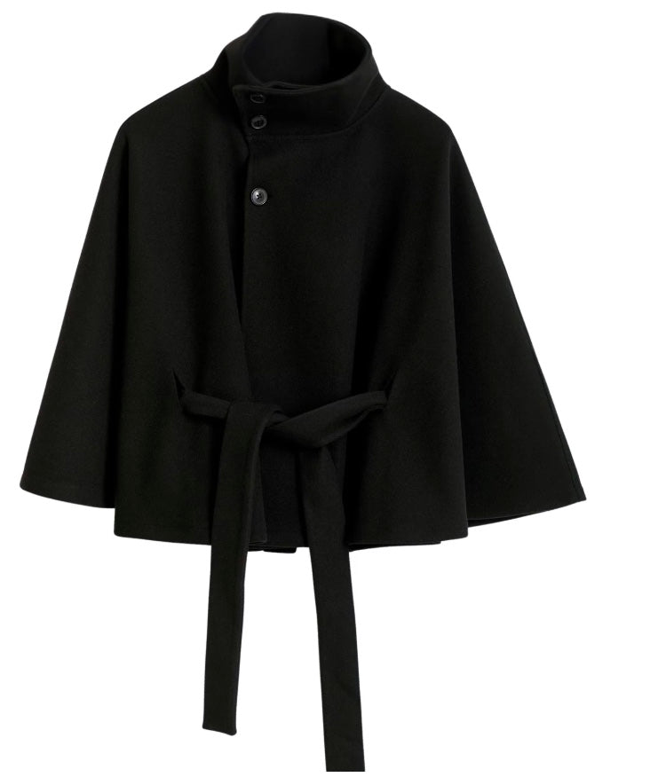Detailed shot of the fabric texture on a women's high collar belted winter coat, indicating warmth.