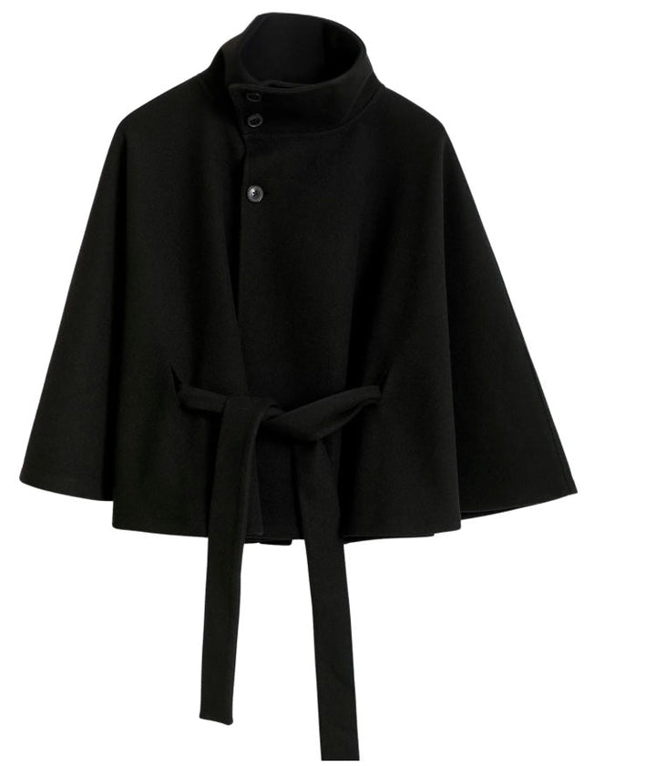 Detailed shot of the fabric texture on a women's high collar belted winter coat, indicating warmth.