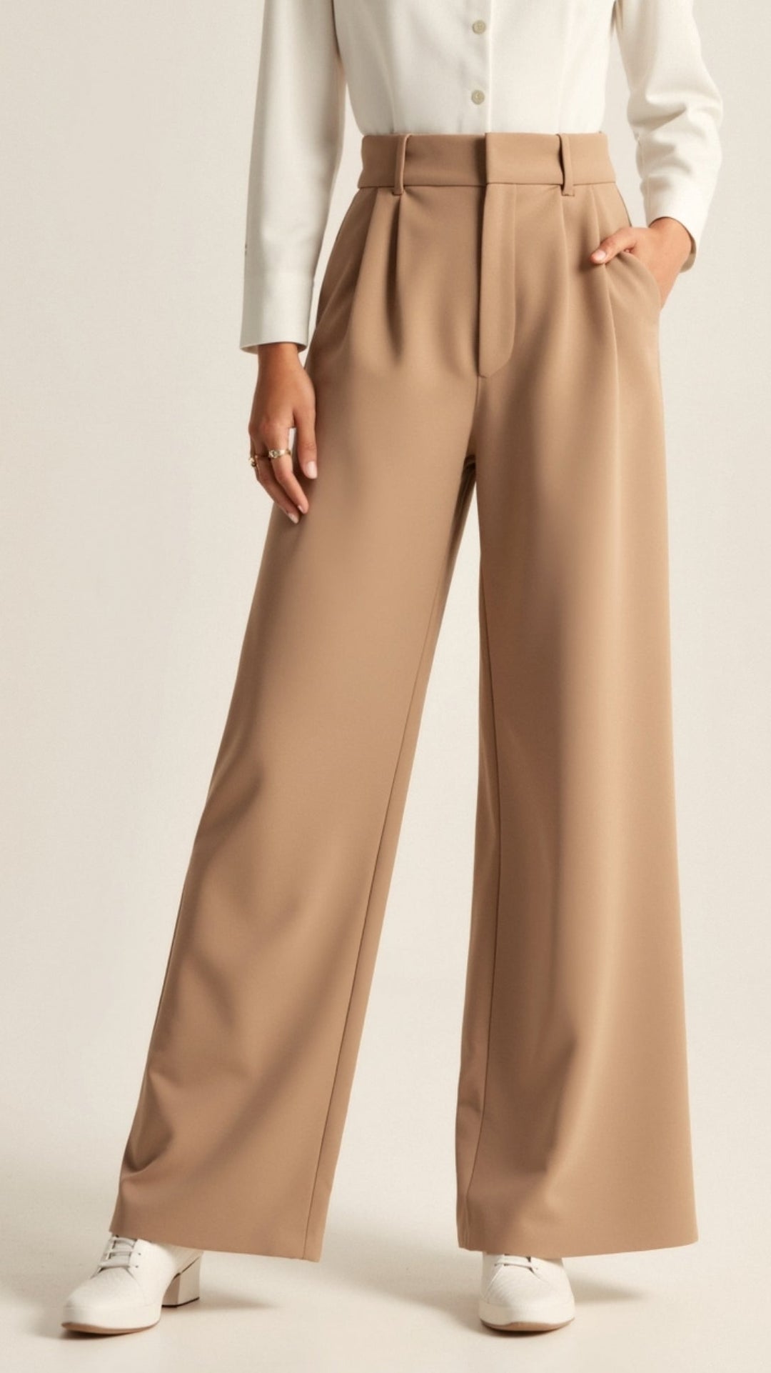 Detail shot of the waistband on women's high waisted wide leg trousers, flattering fit