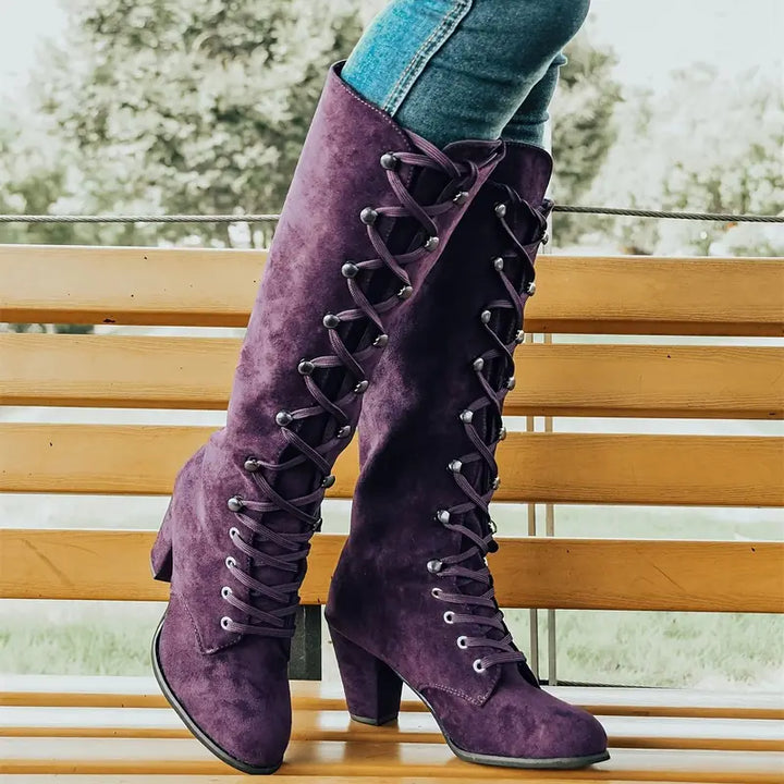 Elegant women's knee-high block heel boots in black, perfect for fall and winter fashion.
