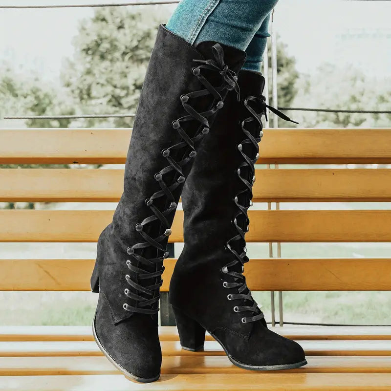 Stylish women's knee-high block heel boots with a sleek design, ideal for dressy or casual wear.