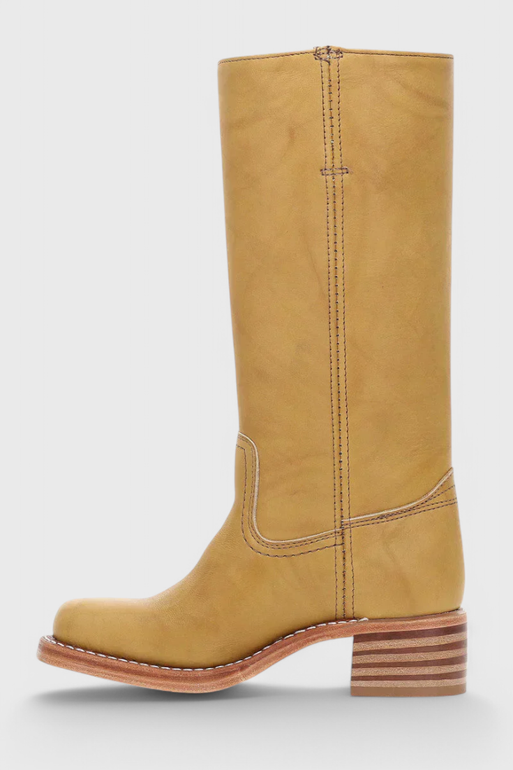 Women's sophisticated knee-high boots with comfortable stacked heel, ideal for winter elegance.