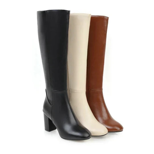 Elegant women's knee-high heeled boots in black faux leather with side zipper, perfect for fall fashion.