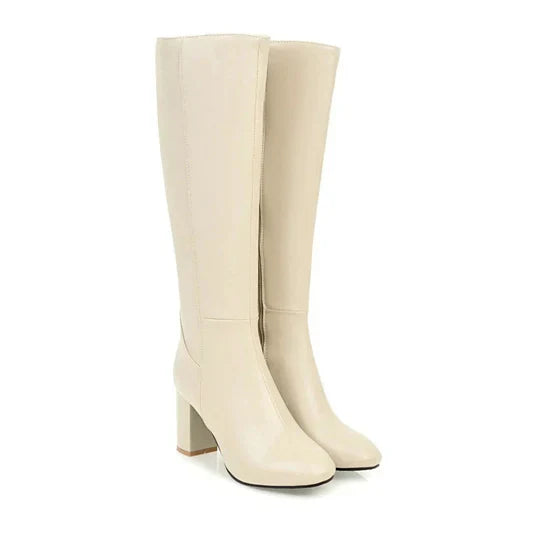 New women's elegant heeled knee-high boots in faux leather, suitable for winter and fall wardrobes.