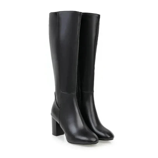 Stylish women's knee-high boots with a comfortable heel, made from faux leather for an elegant look.