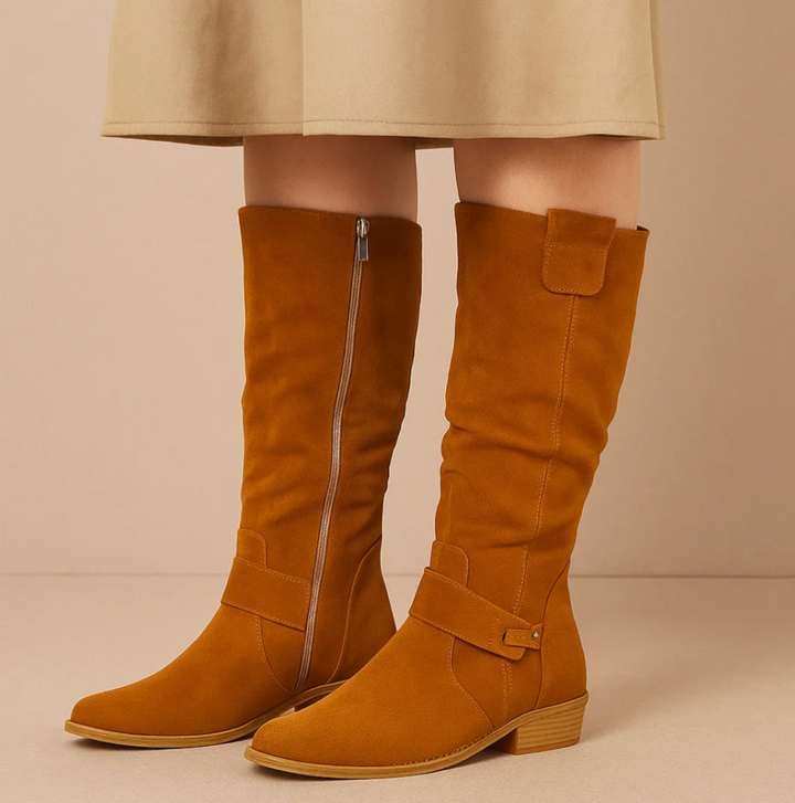 Close-up of elegant women's knee-high suede boots, highlighting the quality suede material