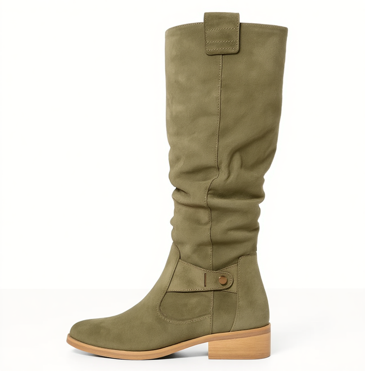 Detail of the soft suede on women's elegant knee-high boots, emphasizing luxury and comfort