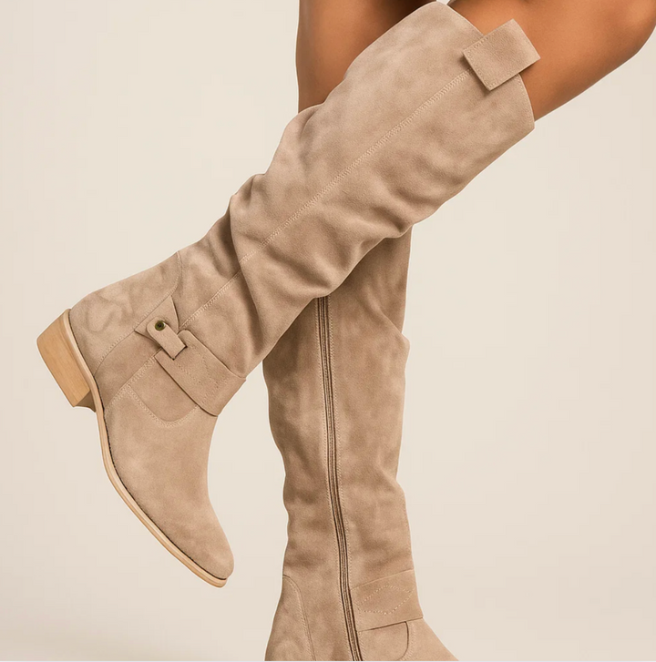 Women's black knee-high suede boots, showcasing a sleek and elegant design for cold weather
