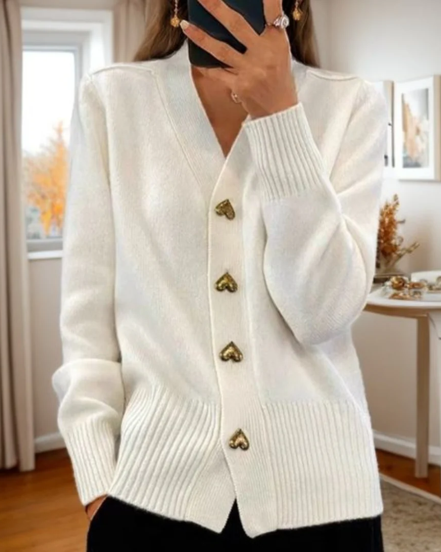 Warm women's knitwear cardigan, v-neck, elegant heart buttons, ideal for cooler weather.