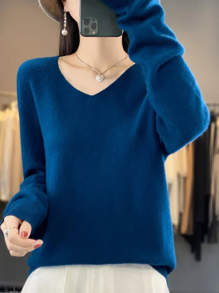 Woman models elegant knit sweater, styled for cozy fall day or chic casual winter outing.