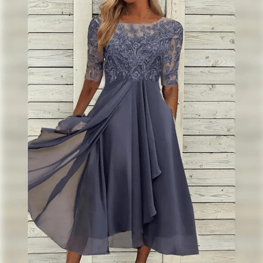 Beautiful women's elegant midi dress featuring intricate lace detail and a graceful flowing skirt.