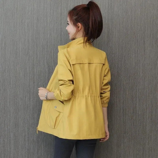 Elegant women's lightweight waterproof trench coat in classic beige, perfect for spring outerwear