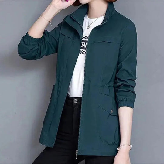 Detail of women's waterproof trench coat fabric, showing lightweight material and elegant design