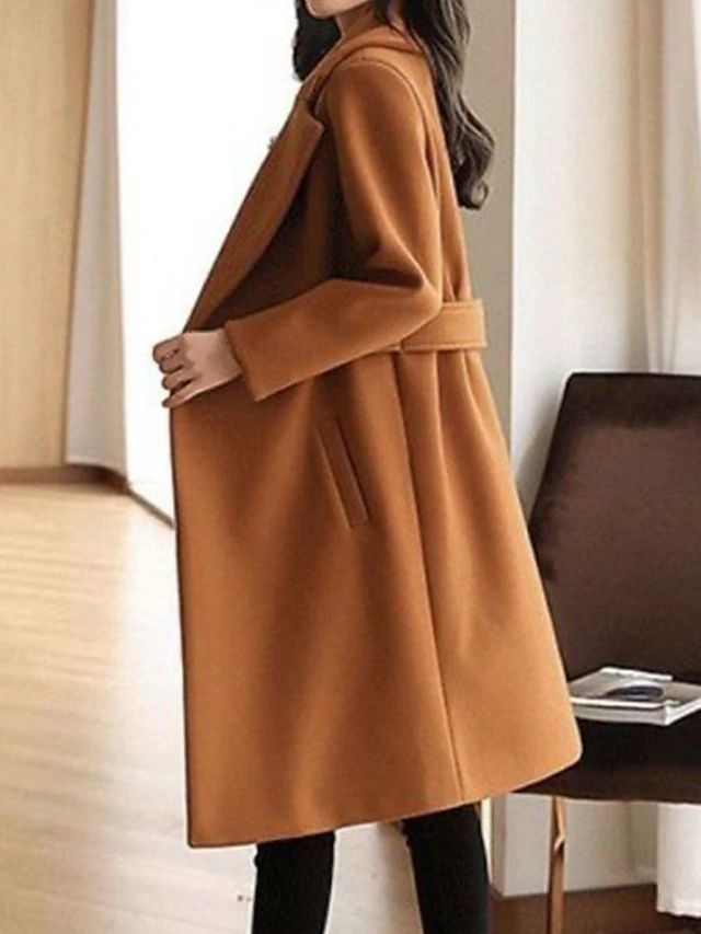 Stylish women's black long trench coat, a versatile and elegant outerwear piece for formal occasions.