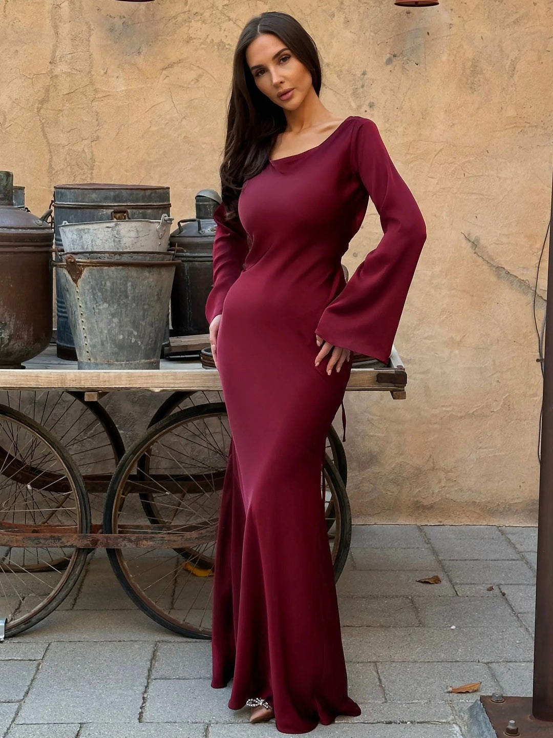Women's elegant evening maxi dress with long sleeves, a beautiful party gown for sophisticated women.