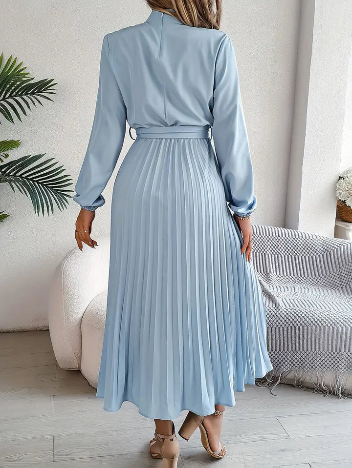 Modest fashion: women's long sleeve pleated maxi dress with a stylish belt, suitable for casual chic.
