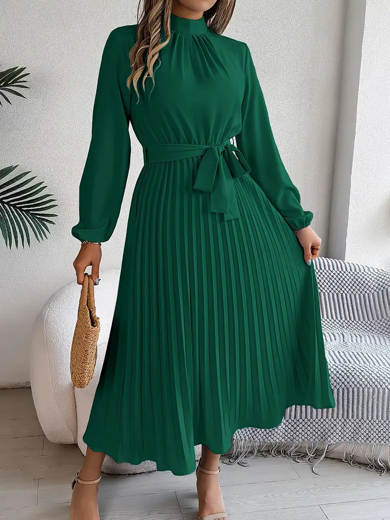 Close-up of the pleated detail on a women's long sleeve belted maxi dress, showcasing elegant fabric.