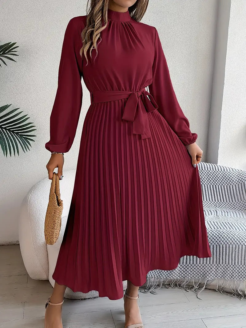 Model wearing a flowing women's long sleeve pleated belted maxi dress, ideal for an evening out.