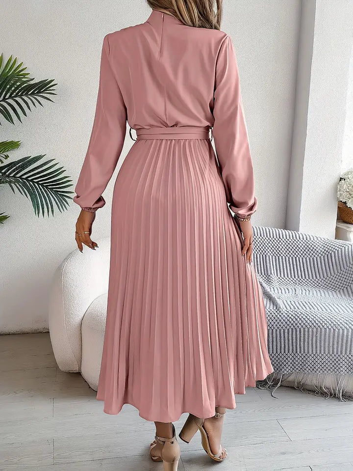 Detailed shot of the belt on a women's pleated long sleeve maxi dress, enhancing its elegant silhouette.