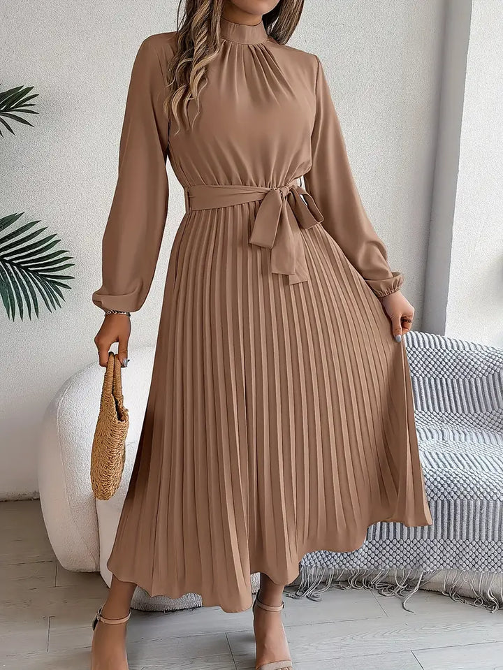 Full-length view of a versatile women's long sleeve pleated belted maxi dress for various occasions.