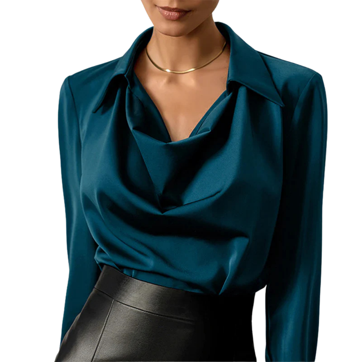 Elegant women's long sleeve satin blouse with draped neckline in a formal setting.
