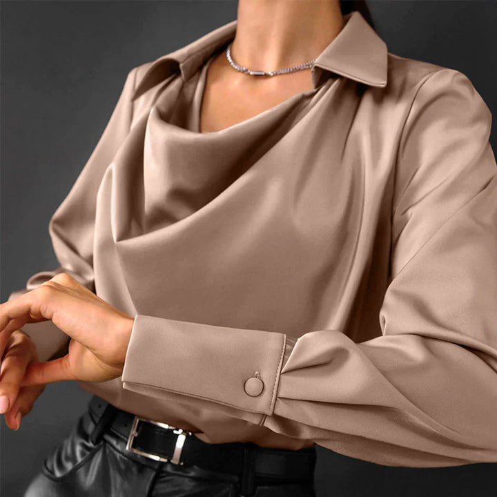 Modern women's satin long sleeve blouse with a beautiful draped neckline, perfect for evening wear.