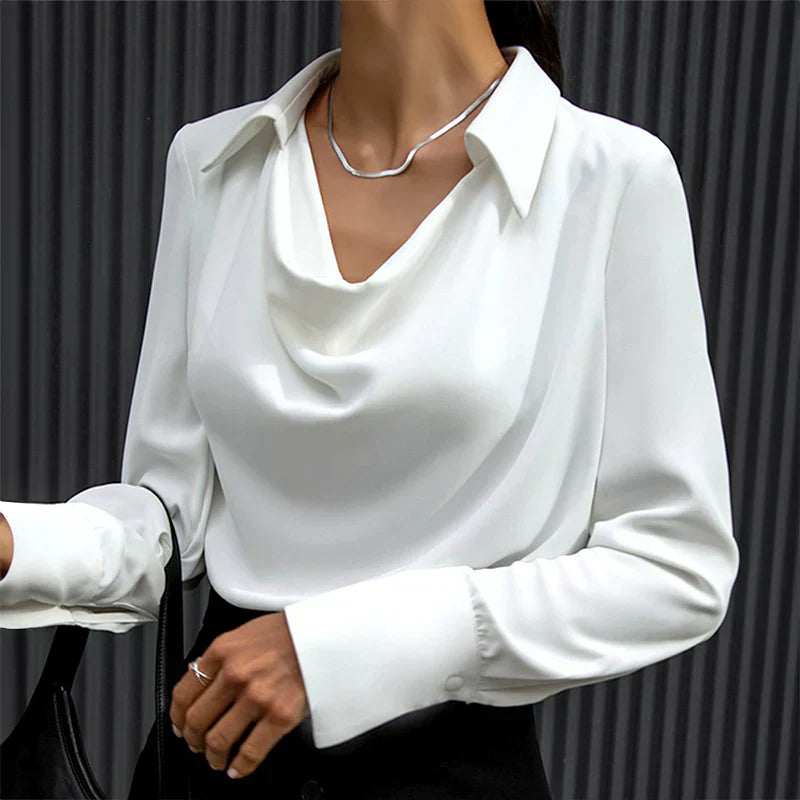 Women's sleek long sleeve satin blouse, highlighting its unique draped neckline and soft fabric.