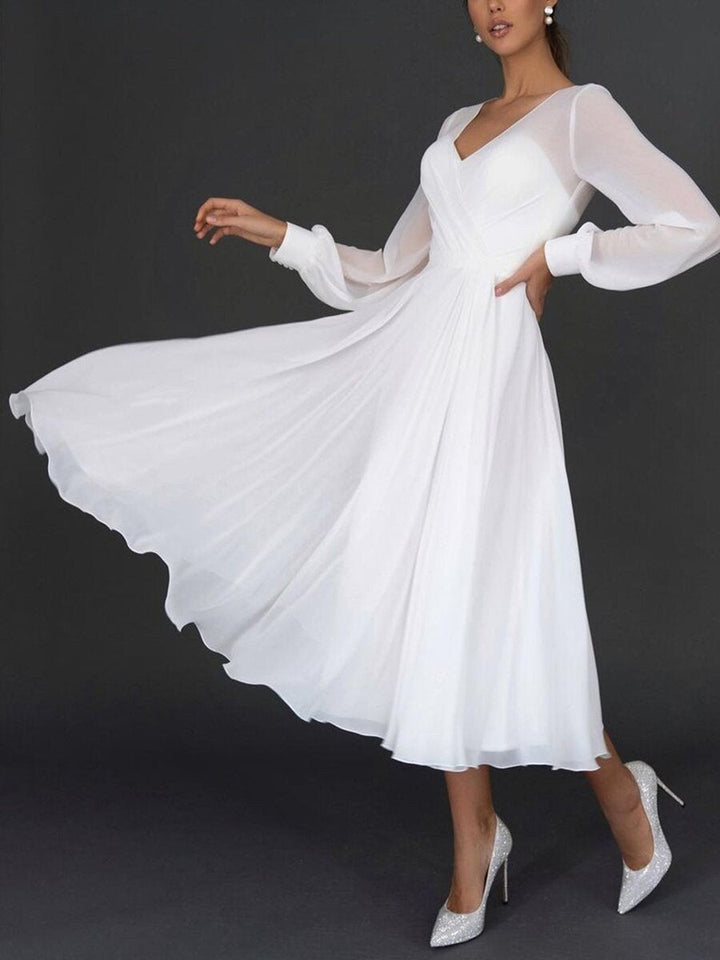 Women's elegant pleated long sleeve v-neck gown. Perfect party dress or formal wear for special events.