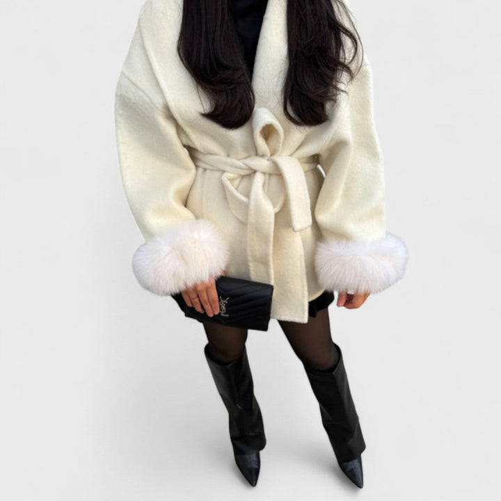 Elegant women's long winter coat with luxurious faux fur collar and cuffs, perfect for cold weather.