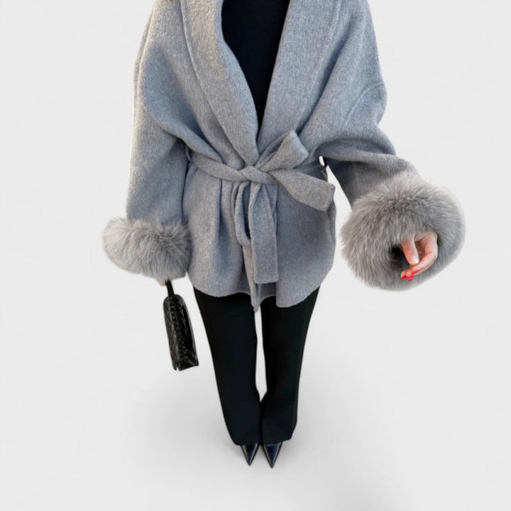 Fashionable women's elegant coat with a stand-up collar and faux fur accents, suitable for various occasions.